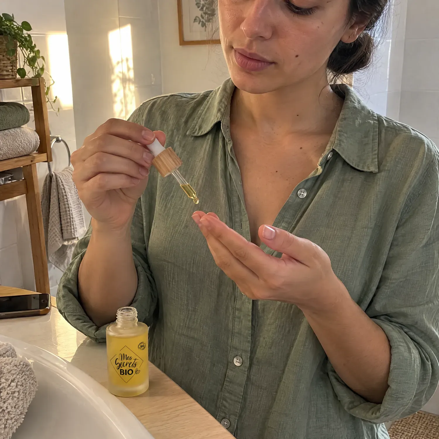 Femme appliquant le sérum illuminateur bio Mes Secrets Bio à la pipette