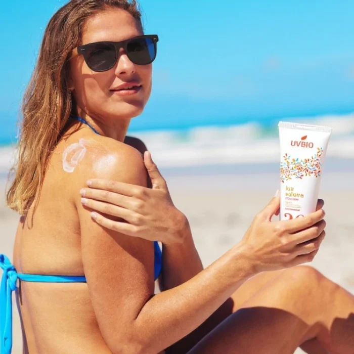 Une femme se passe de la crème solaire